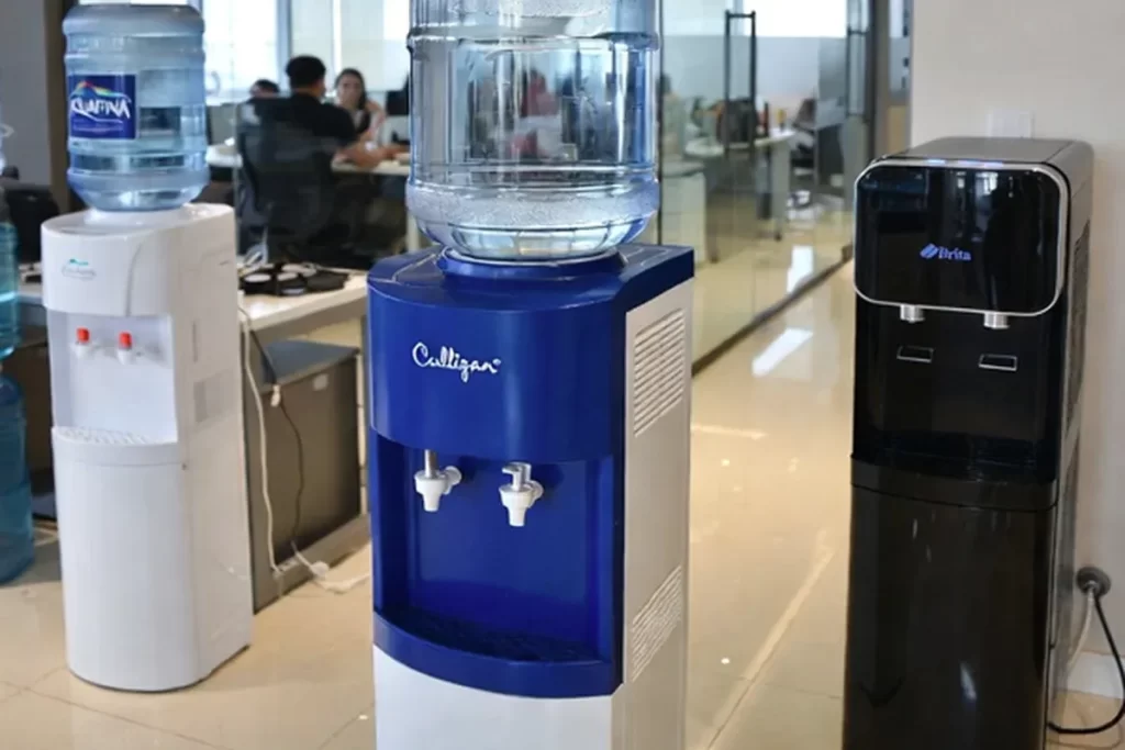 Gym staff cleaning a commercial bottle filling station
