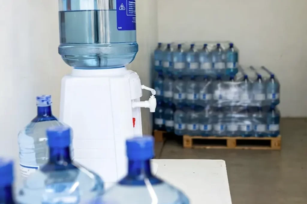 Facilities employee checking a water cooler in an education building