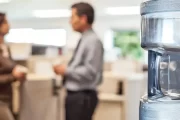 Laboratory employees using a drinking water station outside controlled workspace