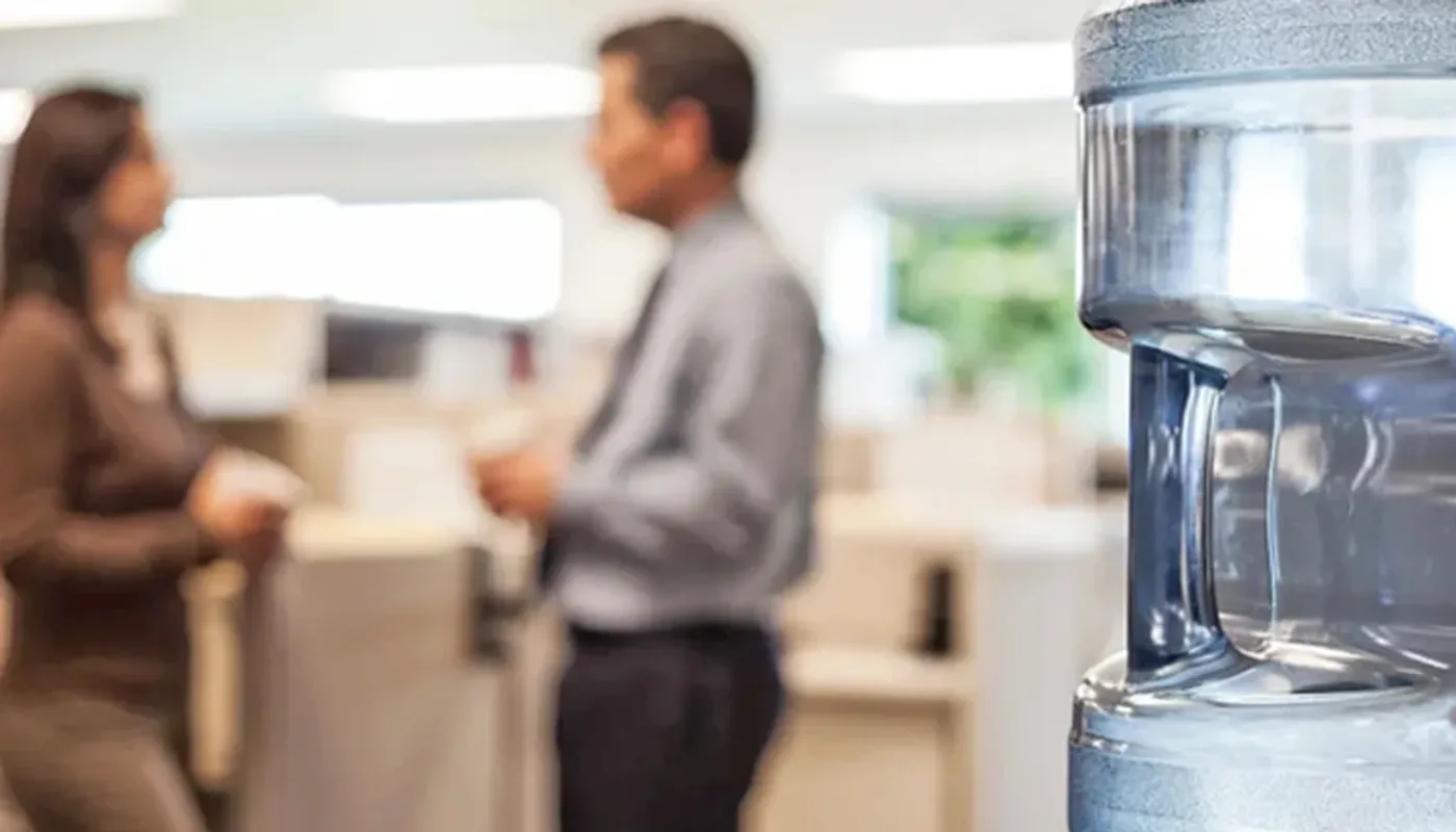 Laboratory employees using a drinking water station outside controlled workspace