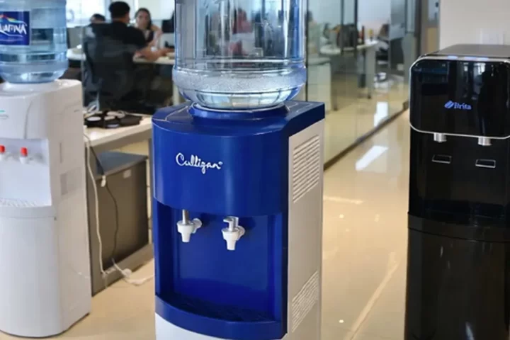 Call center employees using a water station during a break