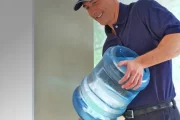 Senior living administrative staff near a workplace water dispenser