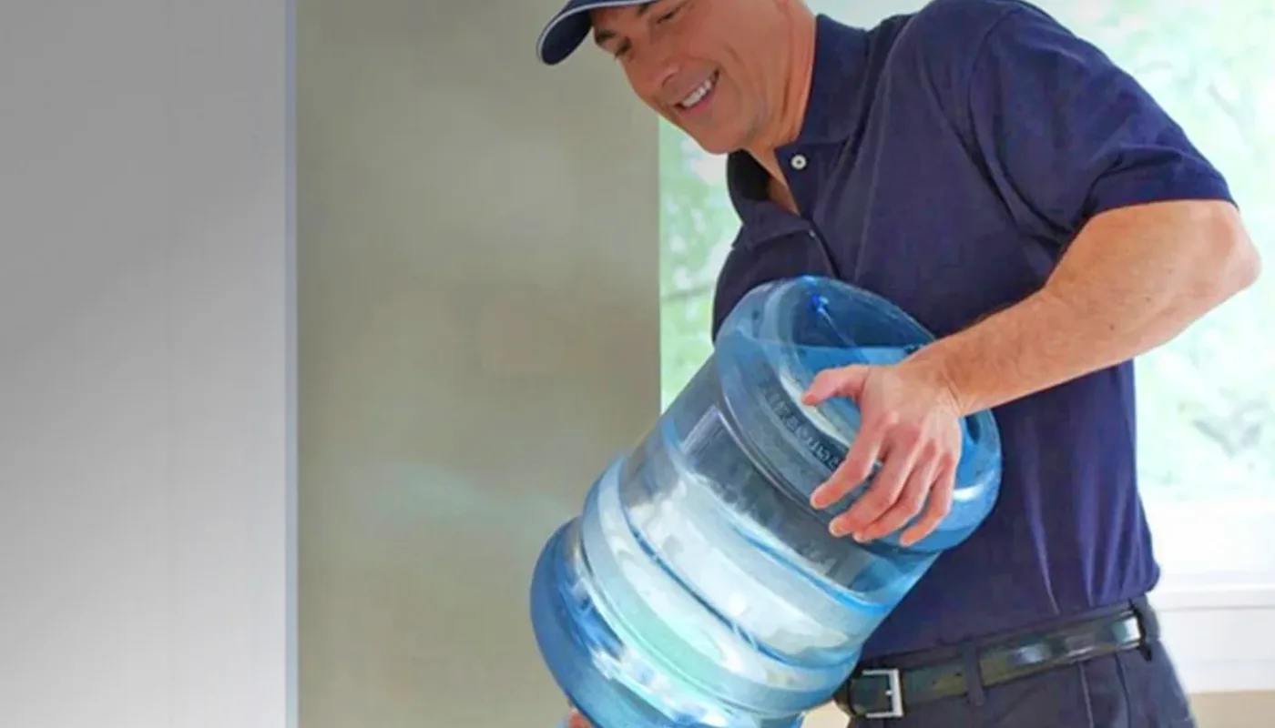 Senior living administrative staff near a workplace water dispenser