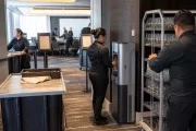 Hotel banquet staff using a commercial water station while preparing a conference space